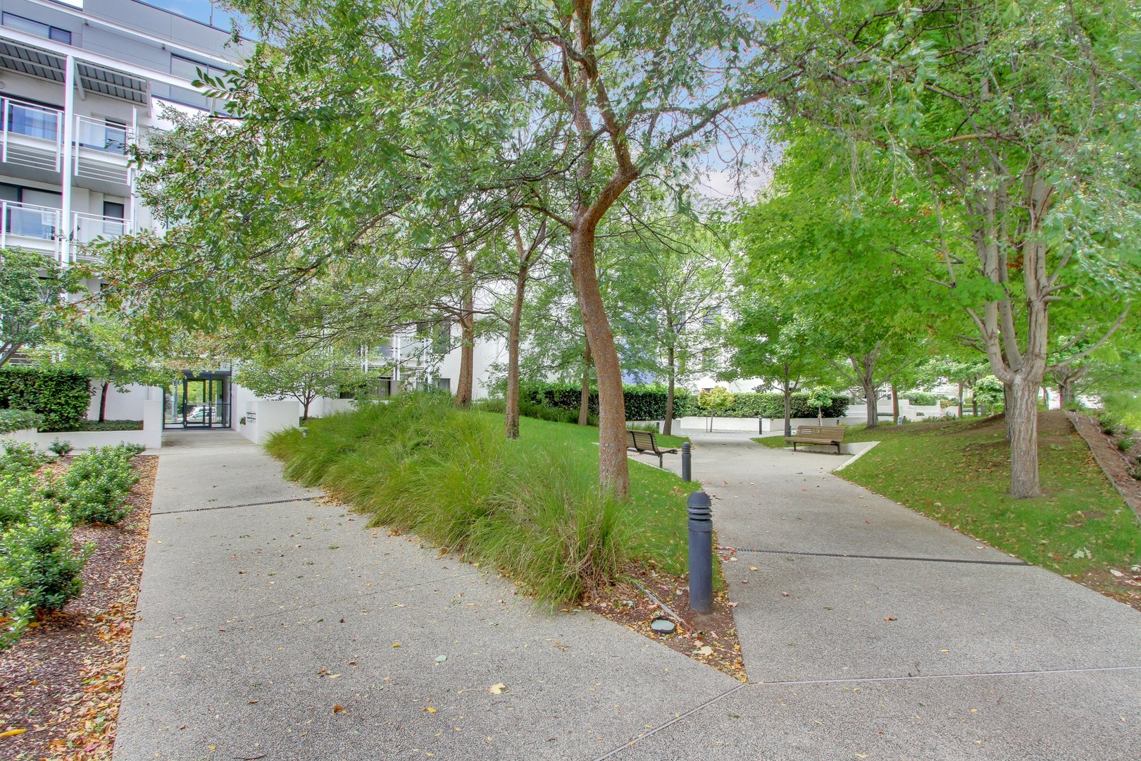 Landscaped pedestrian paths beside the apartment complex